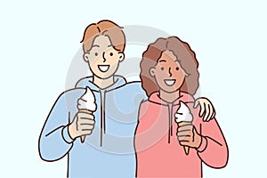 Smiling interracial couple hug eat ice cream
