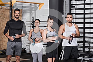 Smiling interracial sportsmen and sportswomen holding