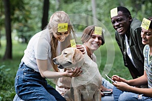 Smiling interracial teenagers with stickers looking