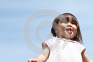 Smiling Japanese girl under the blue sky
