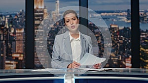 Smiling journalist presenting news at night studio closeup. Anchor woman talking