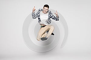 Smiling joyful man jumping isolated on a white background