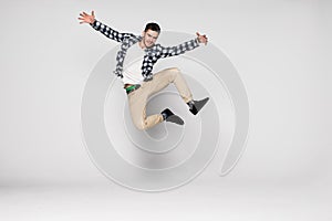 Smiling joyful man jumping isolated on a white background