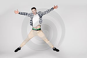 Smiling joyful man jumping isolated on a white background