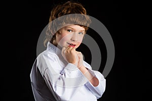 Smiling karate boy in white kimono isolated on