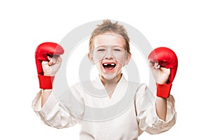 Smiling karate champion boy gesturing for victory