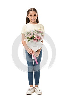 smiling kid with bouquet of flowers looking at camera photo