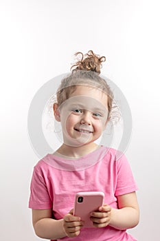 Smiling kid has got a new smart phone on her birthday