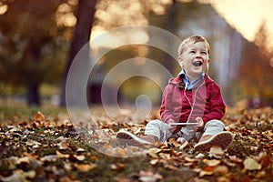 Smiling kid listen music on smartphone. Family, childhood, season and people concept