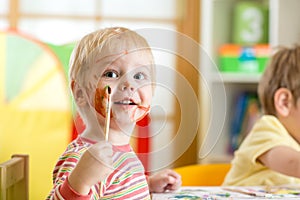 Smiling kid painting at home