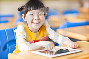 Smiling kid using tablet or ipad