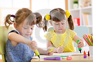 Smiling kids drawing together at hobby group indoors