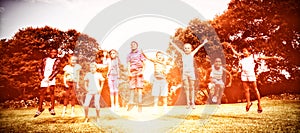 Smiling kids jumping together during a sunny day