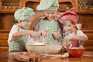 Smiling kids make a mess in the kitchen