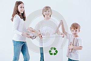 Smiling kids segregating paper waste