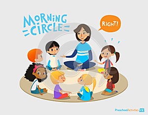 Smiling kindergarten teacher talks to children sitting in circle and asks them questions. Preschool activities and early