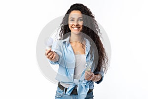 Smiling Lady Choosing Compact Fluorescent Lamp Lightbulb Standing, White Background