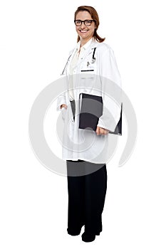 Smiling lady doctor with medical file in hand