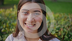 Smiling lady enjoy park leisure looking camera close up. Portrait joyful woman