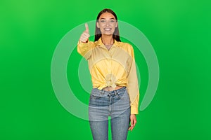 Smiling Lady Gesturing Thumbs Up Standing Over Green Background