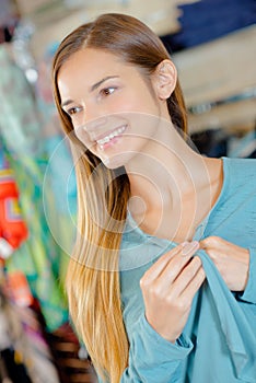 Smiling lady holding lapels blue jacket