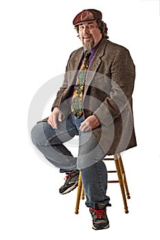 Smiling large man sits in relaxed pose