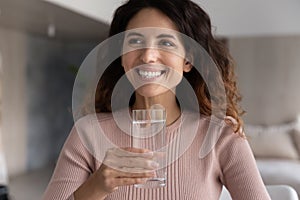 Smiling Latin woman drink mineral clean water