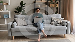 Smiling latina female freelancer work consult from home on laptop