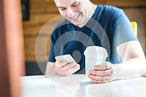 Smiling and laughing happy man using mobile phone.
