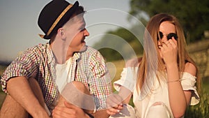 Smiling and laughing people having good time outside on summer warm day. Dating, love, happy, smlile, lought, talking. Couple