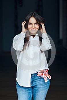 Smiling laughing white Caucasian brunette young beautiful girl woman model with long dark hair and brown eyes in white shirt