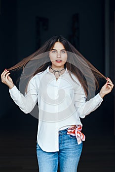 Smiling laughing white Caucasian brunette young beautiful girl woman model with long dark hair and brown eyes in white shirt