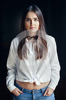 Smiling laughing white Caucasian brunette young beautiful girl woman model with long dark hair and brown eyes in white shirt