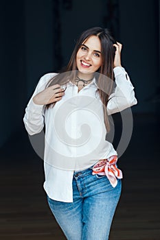 Smiling laughing white Caucasian brunette young beautiful girl woman model with long dark hair and brown eyes in white shirt