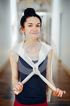 smiling laughing white Caucasian brunette young beautiful woman student with dark hair and brown eyes, standing in hall of college