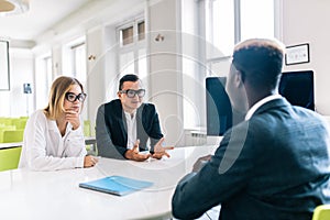 Smiling lawyer, realtor or financial advisor consulting young couple thanking for advice, insurance broker or bank worker discuss