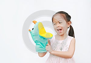 Smiling little Asian child girl hand wear and playing Rhinoceros puppets on white background. Educations concept