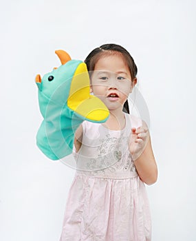 Smiling little Asian child girl hand wear and playing Rhinoceros puppets on white background. Educations concept photo