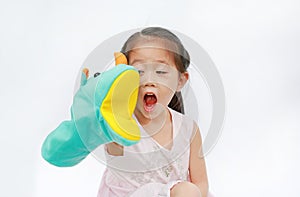 Smiling little Asian child girl hand wear and playing Rhinoceros puppets on white background. Educations concept