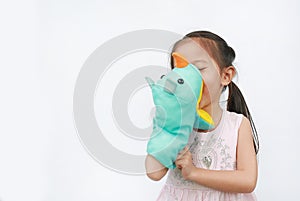 Smiling little Asian child girl hand wear and playing Rhinoceros puppets on white background. Educations concept