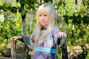 Smiling Little Blond Girl Playing at the Garden