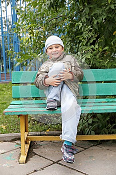 Smiling little boy on bench