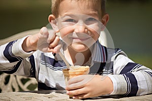 Smiling little boy eating ice-cream