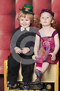 Smiling little boy and girl sitting on