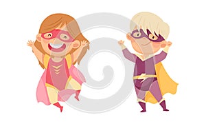 Smiling little boy and girl wearing superheroes costumes set. Kids having fun at carnival or birthday party cartoon