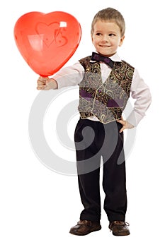 Smiling little boy gives a red balloon