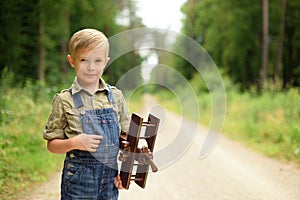 Smiling little boy holding a plane.