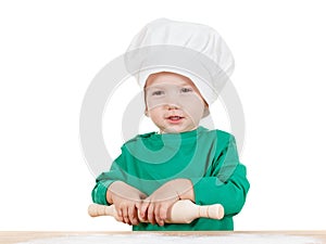 Smiling little boy kneading dough for the cookies