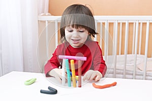 Smiling little boy with playdough