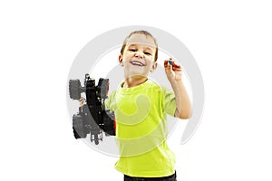 Smiling little boy playing with toy car